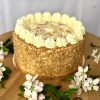 Gourmet handcrafted golden honey cake with cream cheese topping