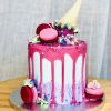 Unique handcrafted luxury pink celebration cake with ice cream topping