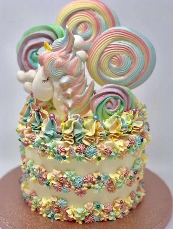 Unique colourful gourmet childrens birthday cake with unicorn and lolly