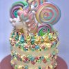 Colourful artisan childrens unicorn birthday cake with lolly