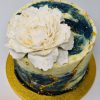 Beautiful blue galaxy sparkle celebration cake topped with a fresh peony flower