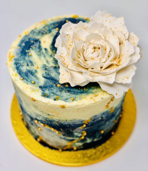 Beautiful showstopping galaxy celebration cake with white peony flower
