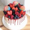 Freshly baked vanilla sponge cake toped with fresh berries and French macarons