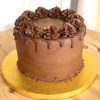 Handcrafted chocolate drip celebration cake filled with ganache